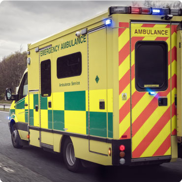 Ambulance driving on the road with its emergency lights on