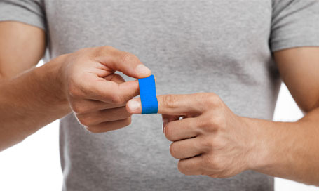 Blue plaster on man's finger