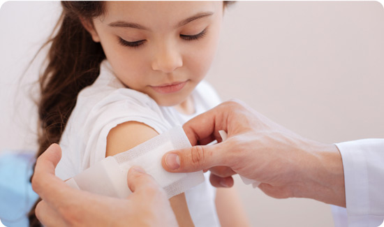 Wound dressing being applied to childs arm