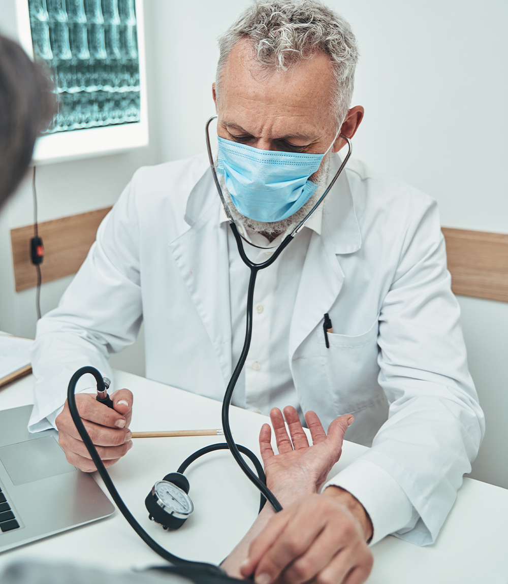 manual sphygmomanometer being used on a patient