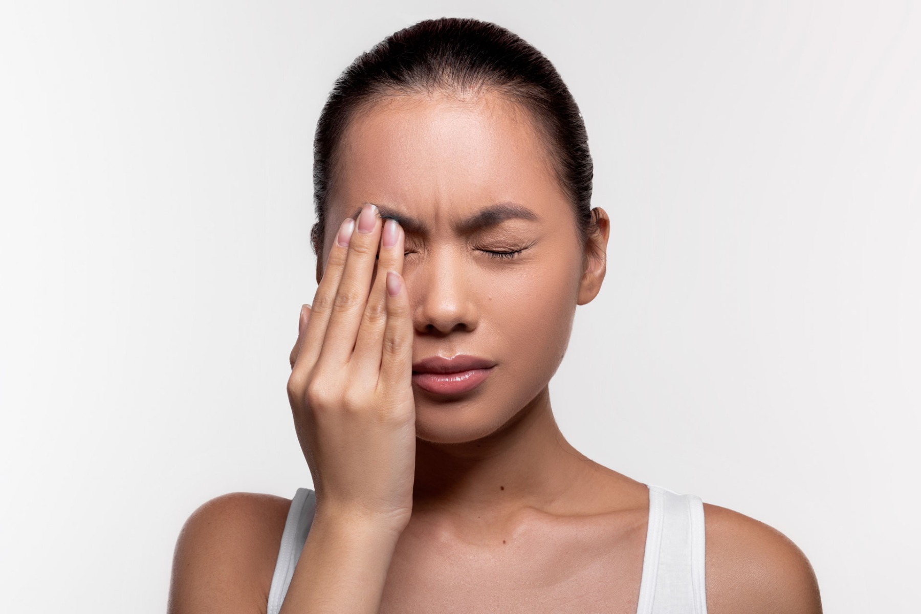 woman suffering from strong eye pain