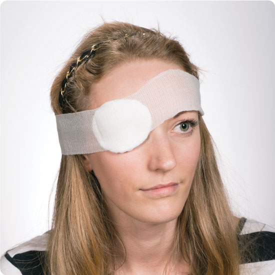 Woman with eyepad dressing over her eye