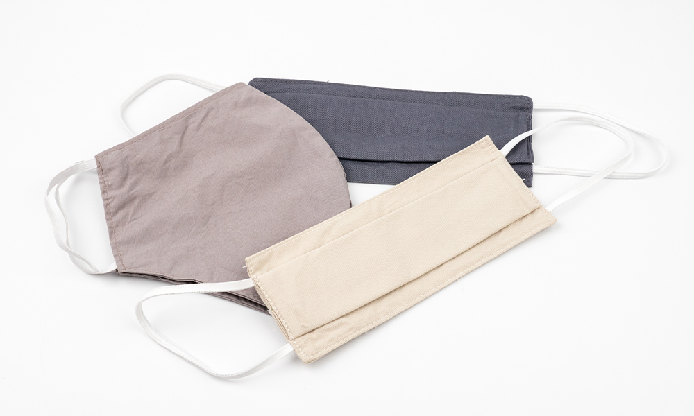 Face protective masks handmade from fabric cloth on white background.