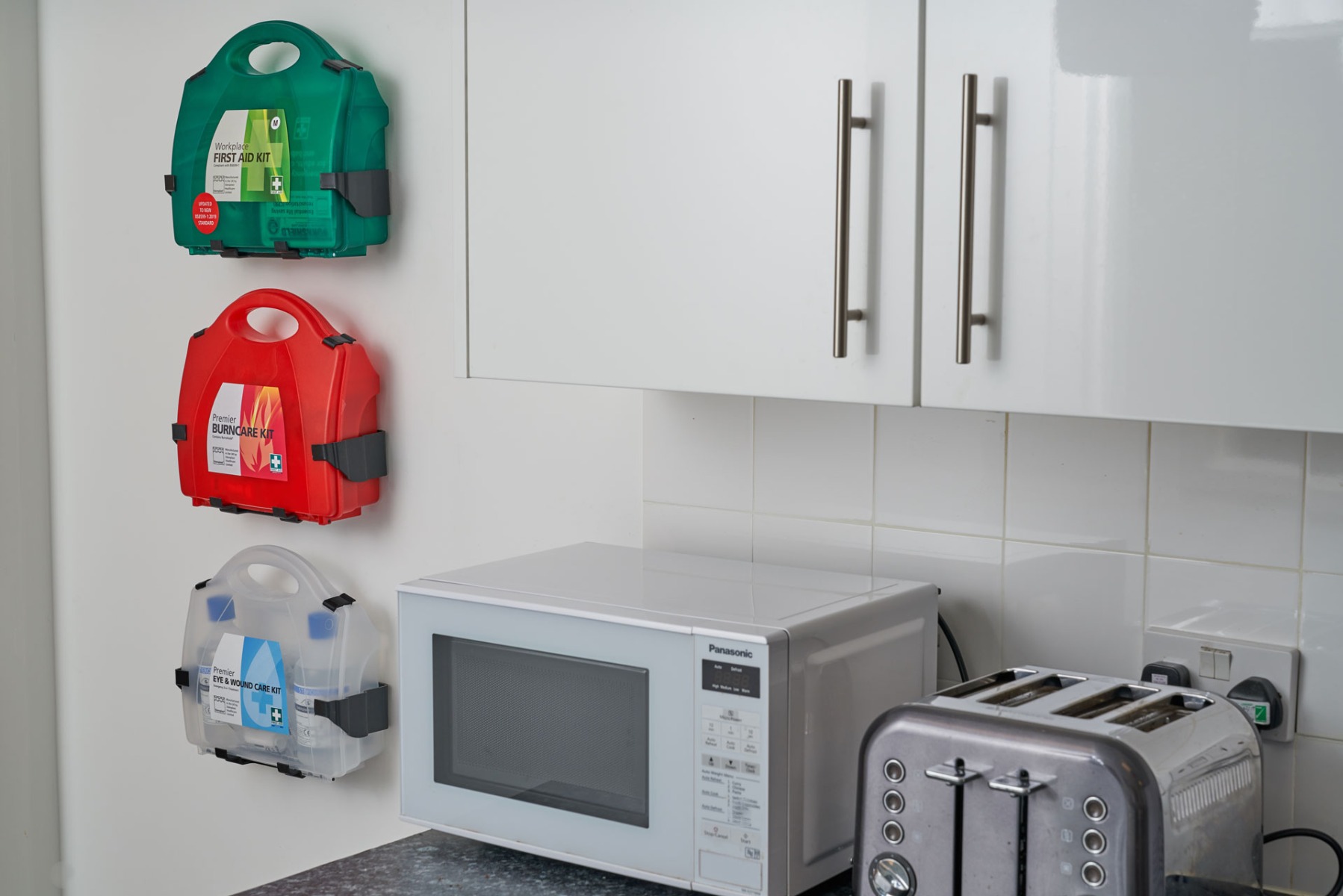 First Aid kits mounted to wall in workplace