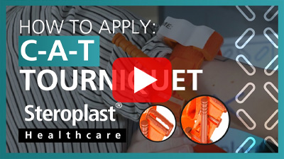 Video thumbnail with a person holding an orange CAT tourniquet, explaining its use. Text overlay reads 'This is how to apply a CAT Tourniquet,' with a play button centred on the image.