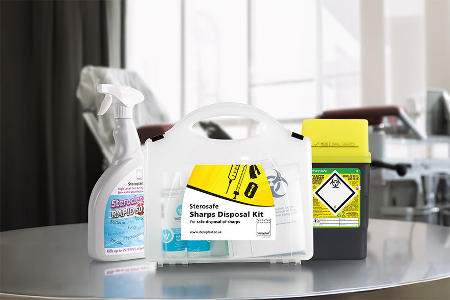 A Sterosafe sharps disposal kit, Steroclenz cleaning spray, and a medical sharps container displayed on a reflective surface in a clinical setting