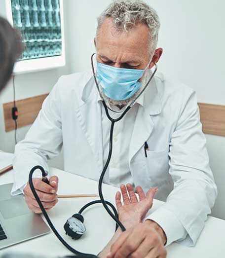 manual sphygmomanometer being used on a patient
