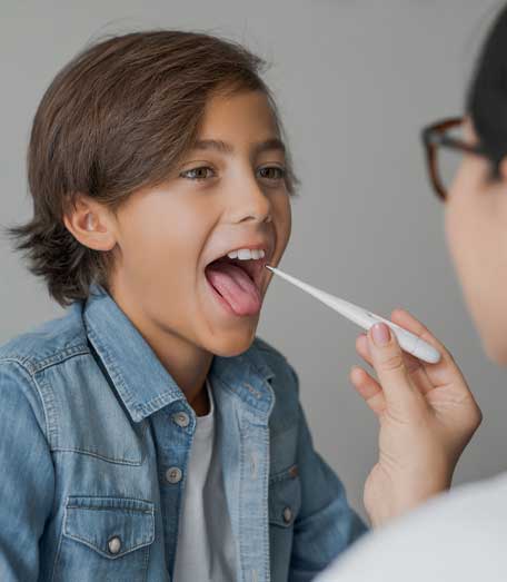 Medical worker using thermometer