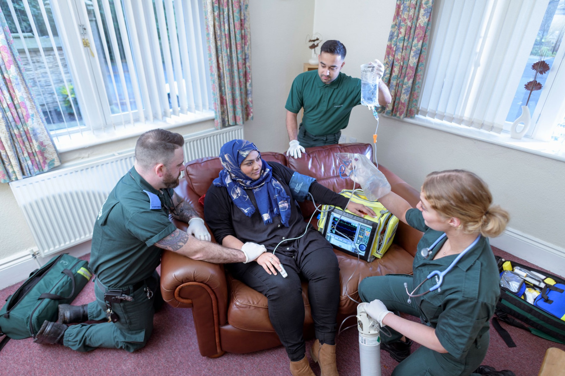 Emergency paramedics treating patient at home