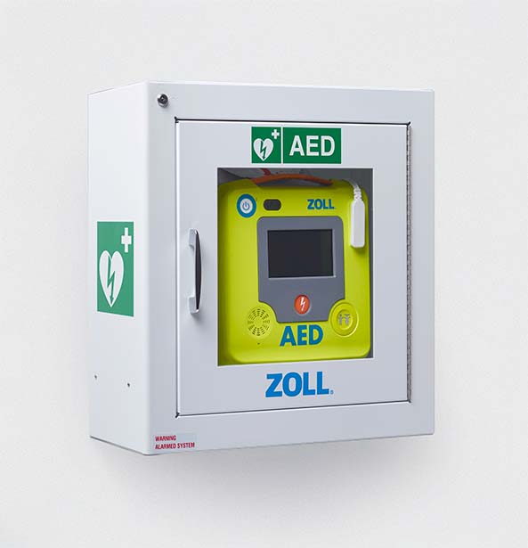 Wall-mounted ZOLL AED 3 in a secure, alarmed cabinet with clear AED signage.