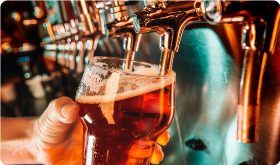 Person Pouring a Pint of Beer