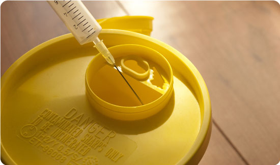 Putting Needle in Sharps Bin