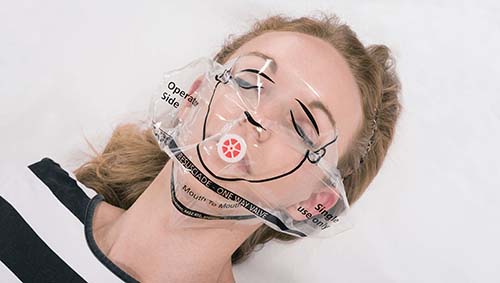 Resusciade face shield with a valve for safe mouth-to-mouth CPR, shown on a mannequin’s face.