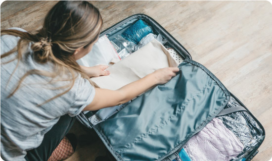 Woman packing suitcase