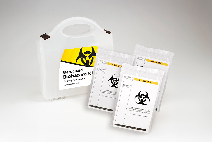 A Steroguard Biohazard Kit, designed for body fluid clean-up, presented with a durable white plastic case featuring a biohazard symbol and bold yellow accents. The kit includes several individually packaged biohazard clean-up components, laid out neatly in front of the case.