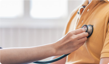 Doctor using a stethoscope to listen to a patients chest