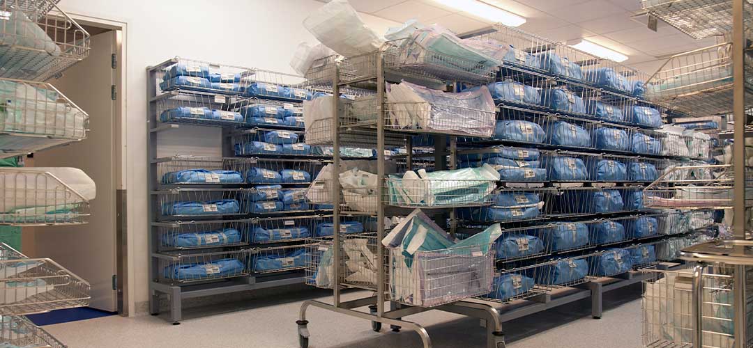 Storage room in a modern hospital, rows of sterile equipment packs in blue fabric.