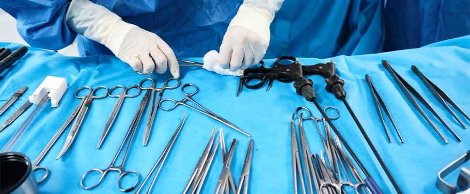 doctor prepares sterile surgical instruments during a surgery