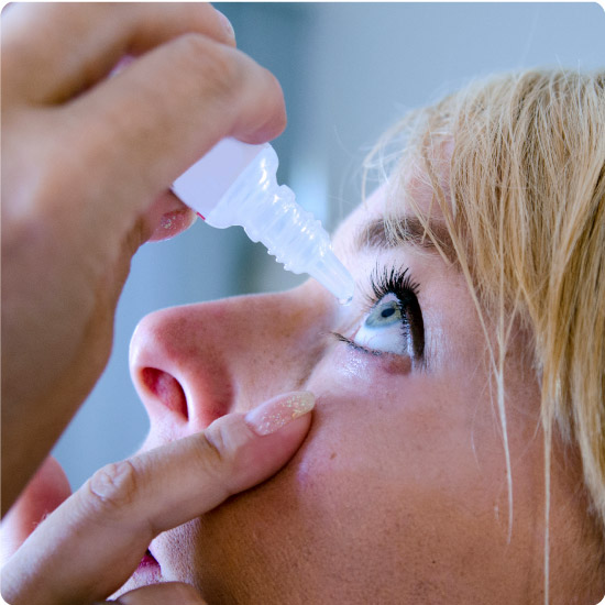 Woman Putting Eyewash in Eye