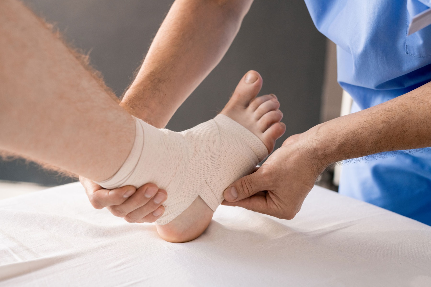 patient wearing a cohesive bandage on their ankle