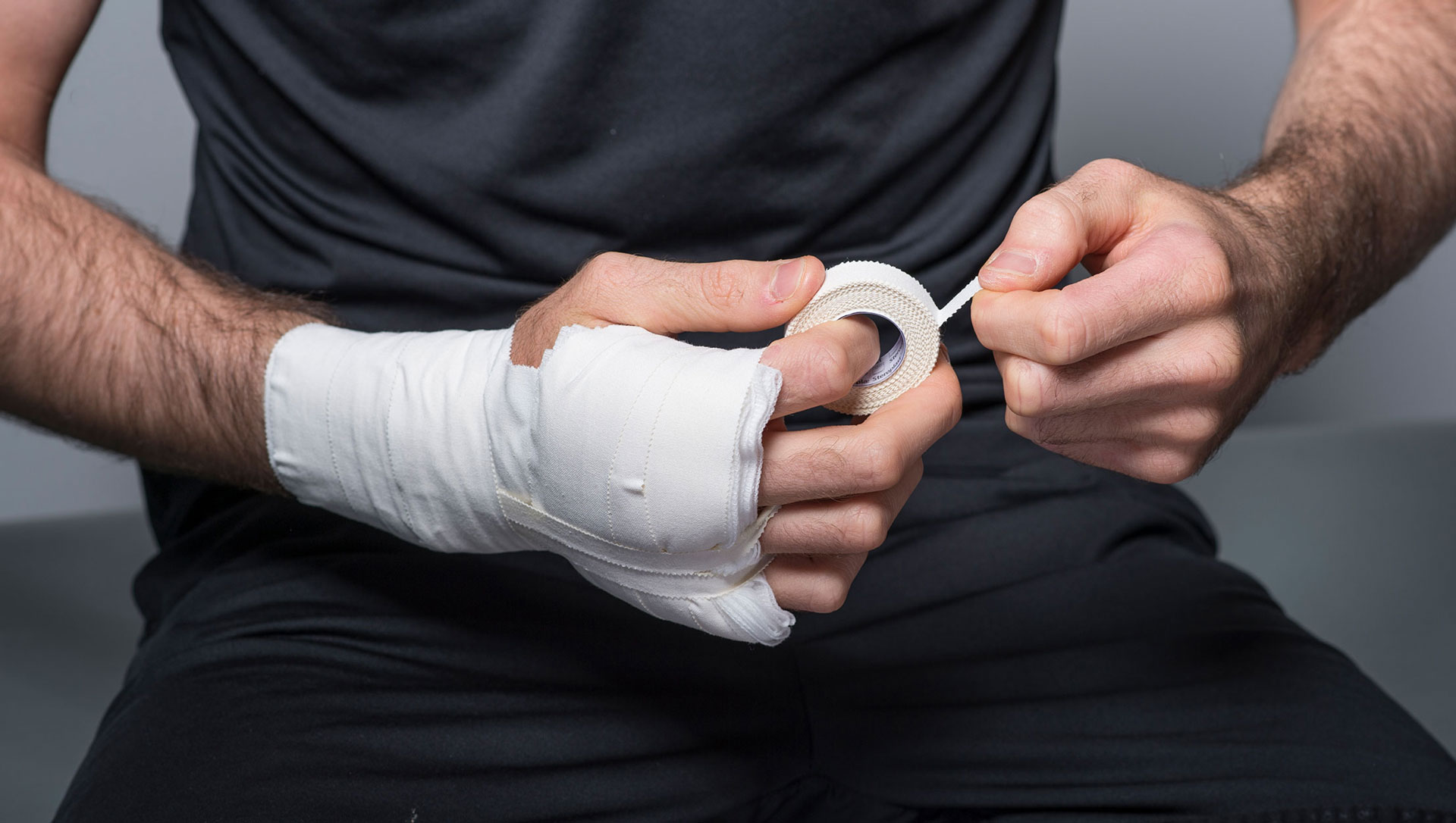 wrist being strapped with zinc oxide tape