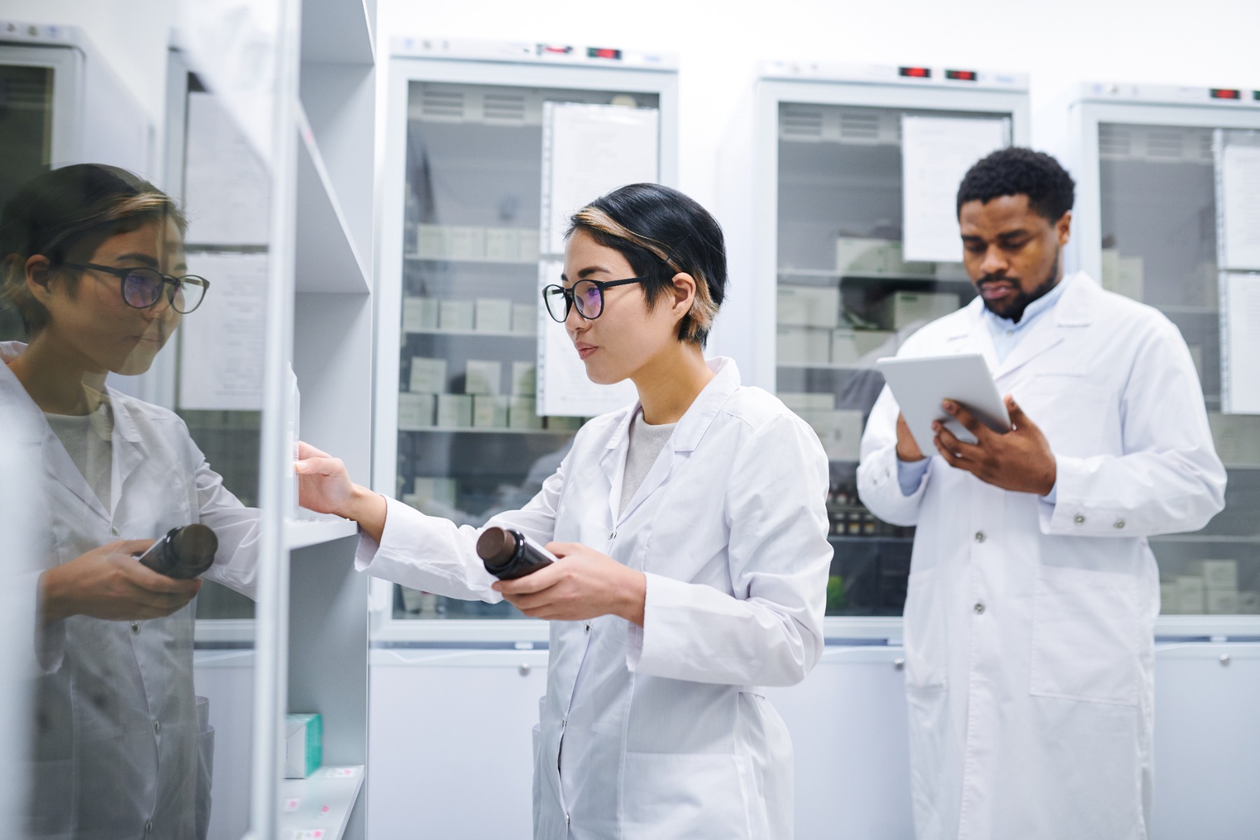 pharmacist sorting medications in storage room