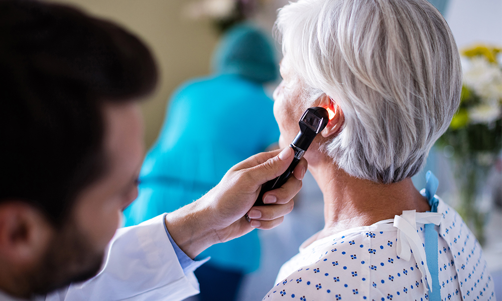 doctor using an otoscope on patient