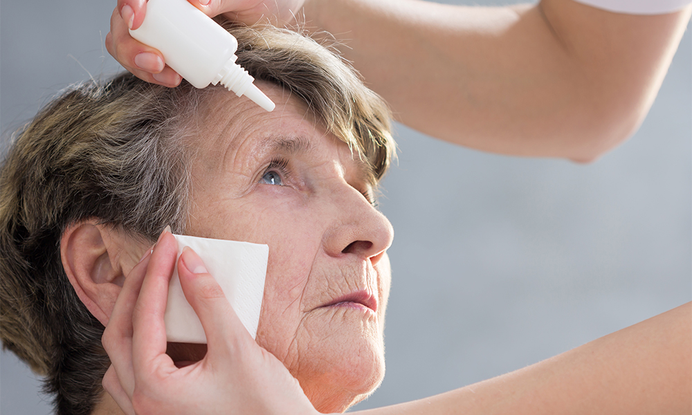 eyedrops being dropped into a patient’s eye