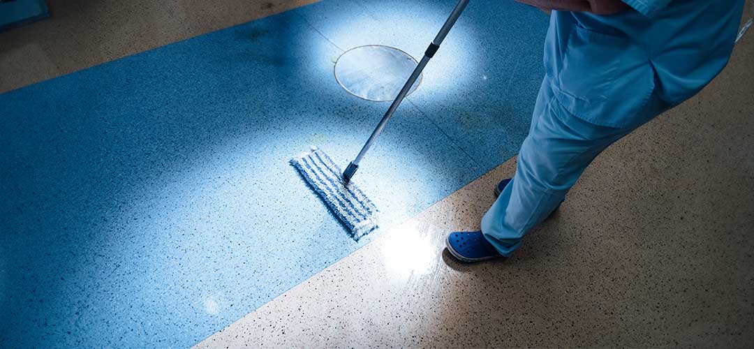 hospital worker doing cleaning in operation room