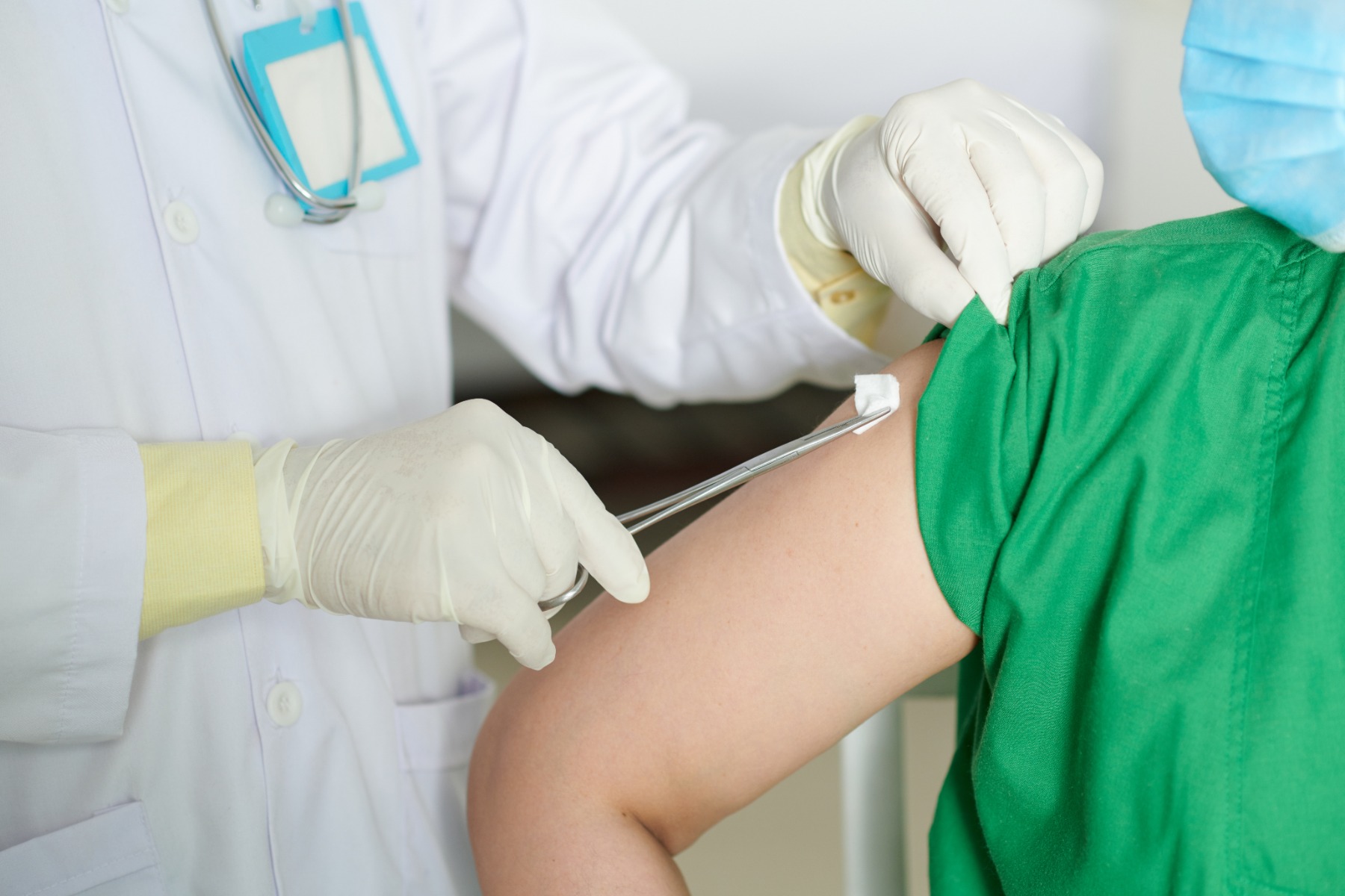 doctor using alcohol prep pad on patients arm