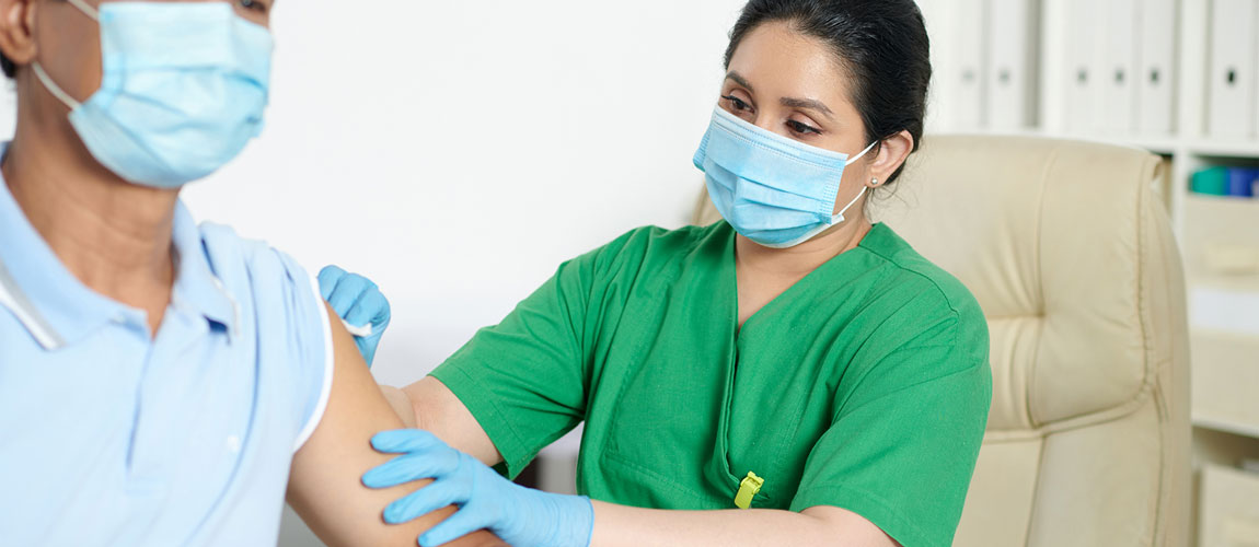 nurse wiping sterile cleansing wipe on patient with gloves