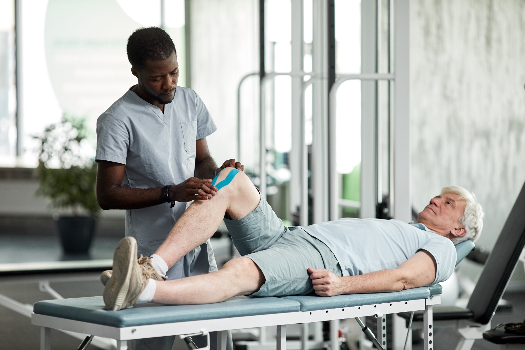 Rehabilitation Therapist Using Tapes