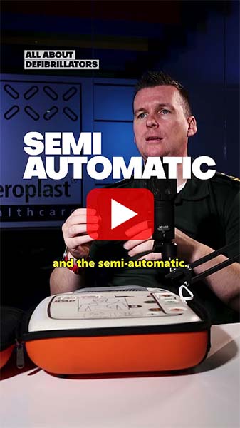 Person explaining the features of a semi-automatic AED model, highlighting its design and use.